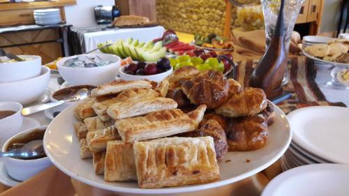 a plate of waffles and pastries on a table at Altos Ushuaia Hotel & Resto in Ushuaia
