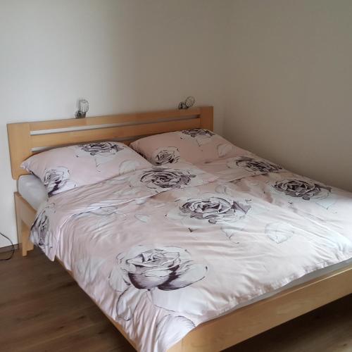 a bed with drawings of roses on it at VilaPavlov in Pavlov