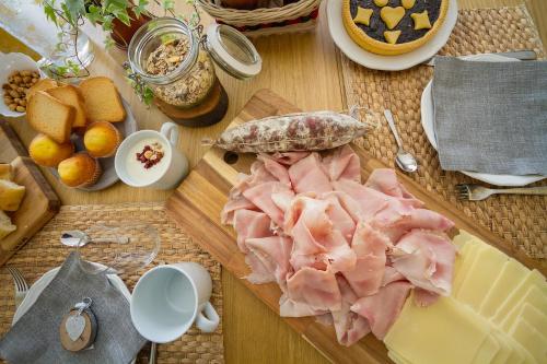 a cutting board with meat and cheese on a table at Agriostello delle Langhe in Farigliano