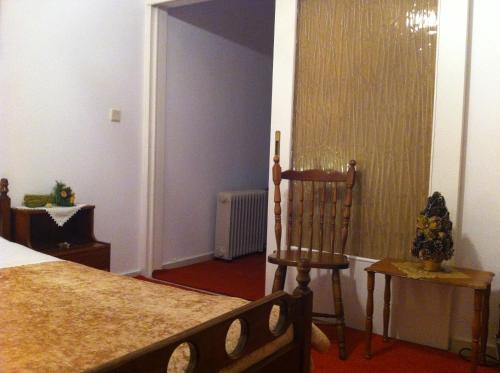 a bedroom with a bed and a chair in it at Chris Studios & Apartments in Lechaio