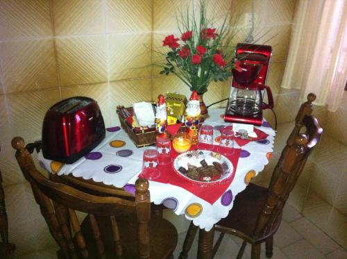 a table with a plate of food and flowers on it at Chris Studios & Apartments in Lechaio