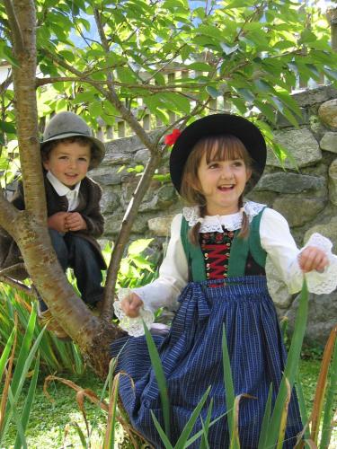 two children dressed in costumes sitting in a tree at Haus Alpenglühn in Sautens