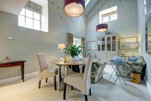 a dining room with a table and chairs at Poppy Barn in Holt