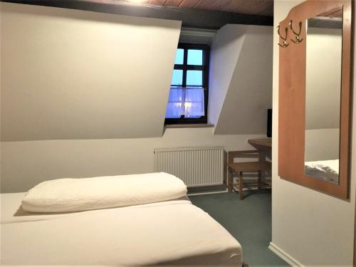 a bedroom with a bed and a window in it at Gasthaus Löwen in Sinsheim