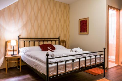 a bedroom with a bed with white sheets at Statek česká lípa Myslovice in Klatovy