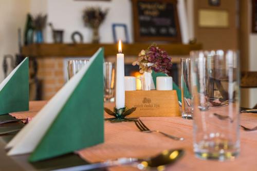 a table with a candle and plates and glasses on it at Statek česká lípa Myslovice in Klatovy
