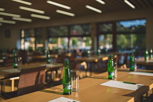 a table in a restaurant with green bottles on it at Statek česká lípa Myslovice in Klatovy