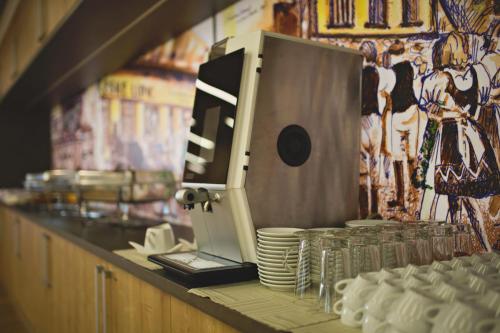 a counter with a food processor on top of plates at Statek česká lípa Myslovice in Klatovy