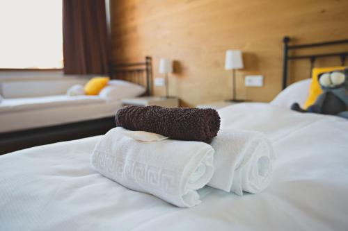a pile of towels sitting on top of a bed at Statek česká lípa Myslovice in Klatovy