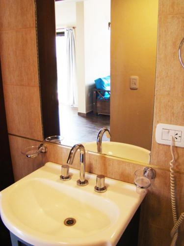 a bathroom with a sink and a mirror at Apart Entrepiedras in Merlo