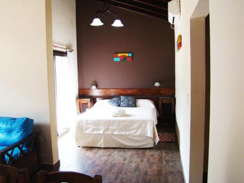 a bedroom with a white bed in a room at Apart Entrepiedras in Merlo