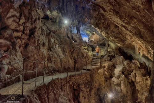 a man walking through a tunnel in a cave at Oikia Vacanze Diso Giulia in Diso