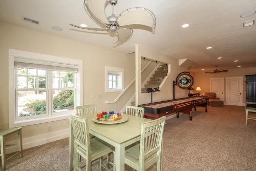 a dining room with a table and a piano at Lay By The Bay in Saugatuck