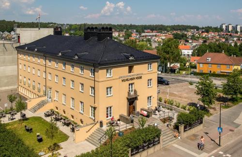 a large yellow building with a black roof at Wilhelmsen House in Tønsberg