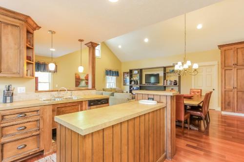 a kitchen with wooden cabinets and a dining room at Nightingale in Saugatuck