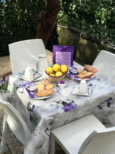a table with plates of bread and fruit on it at Da Francesca in Scilla
