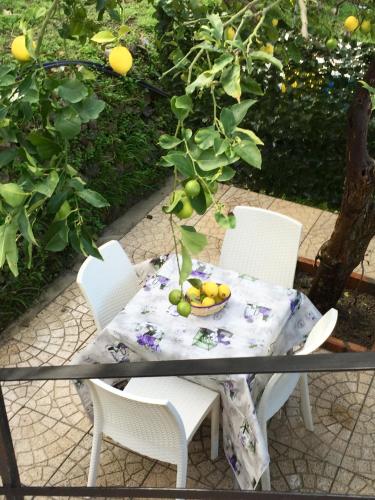 a table and chairs with a bowl of fruit on it at Da Francesca in Scilla
