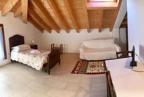 a bedroom with two beds and a rug at Agriturismo Corte Del Brenta in Oriago Di Mira