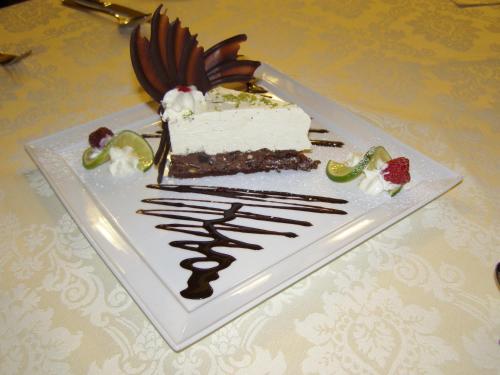 a piece of cake on a plate on a table at Hotel Victoria in Włocławek