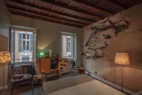una camera da letto con un dipinto di un uomo sul muro di Frattina 57 a Roma