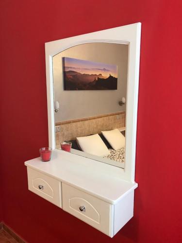 a mirror on a wall with a bed in it at Apartamento Allegra in Arinaga