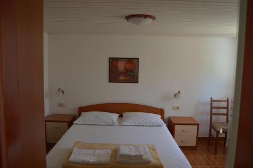 a bedroom with a bed with two towels on it at Apartman Latin 1 in Vodice