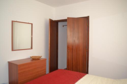 a bedroom with a bed and a dresser and a mirror at TINA - AL Praia da Vitória - RRAL 759 in Praia da Vitória