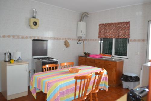 a kitchen with a table with a colorful table cloth at TINA - AL Praia da Vitória - RRAL 759 in Praia da Vitória
