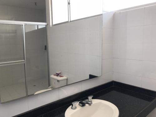 a bathroom with a sink and a shower at Hotel Via 40 in Barranquilla