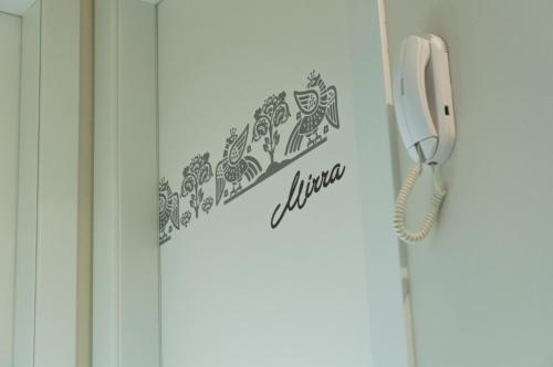 a white phone is hanging on a door at VILLA FENIX OSIO SOTTO in Osio Sotto