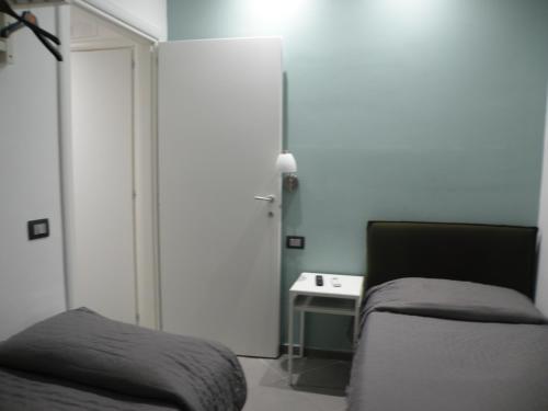 a bedroom with a bed and a table with a lamp at Hotel La Cavalera in Augusta