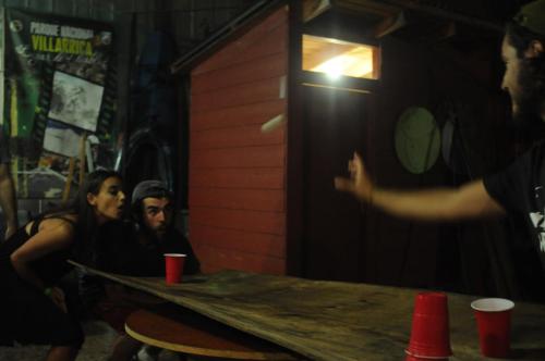 a man and a woman sitting at a table in a bar at Gecko Hostel in Pucón