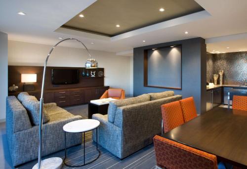 a living room with couches and a dining room at Hyatt Regency Dallas in Dallas