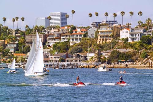 a group of boats in the water near a city at Hyatt Regency Newport Beach in Newport Beach