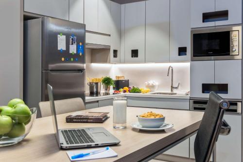 a kitchen with a table with a laptop on it at Hyatt House Gebze in Gebze
