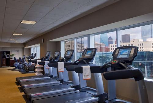 a gym with a row of treadmills at Hyatt Regency Dallas in Dallas
