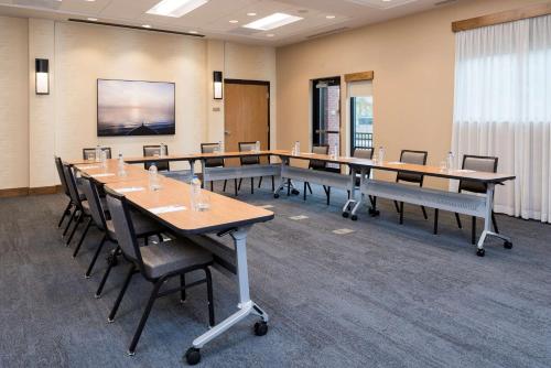 a conference room with long tables and chairs at Hyatt Place Ann Arbor in Ann Arbor