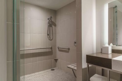a bathroom with a shower with a glass door at Hyatt Regency Houston Galleria in Houston
