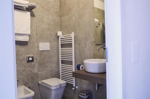 a bathroom with a toilet and a sink at VILLA FENIX OSIO SOTTO in Osio Sotto