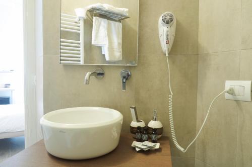 a bathroom with a sink and a blow dryer at VILLA FENIX OSIO SOTTO in Osio Sotto