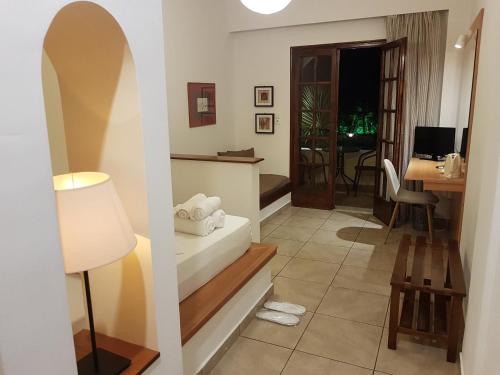 a living room with a lamp and a table at Abelonas Village in Megalokhori