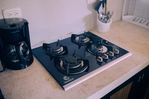 a stove top oven sitting on top of a counter at Lua Villas in Santa Teresa Beach