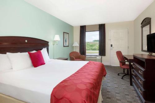 A bed or beds in a room at Ramada by Wyndham Pelham