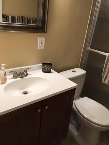 a bathroom with a sink and a toilet at Spanish Main in Cocoa Beach