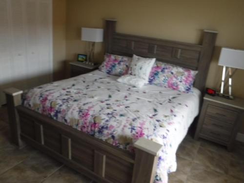 a bedroom with a large bed with flowers on it at Spanish Main in Cocoa Beach