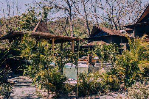 a resort with a swimming pool and a house at Lua Villas in Santa Teresa Beach