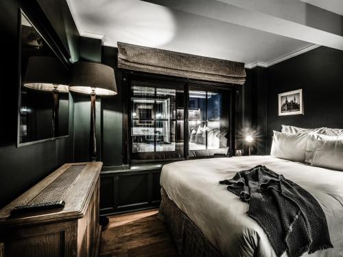 a bedroom with a large bed and a window at 1898 The Post in Ghent