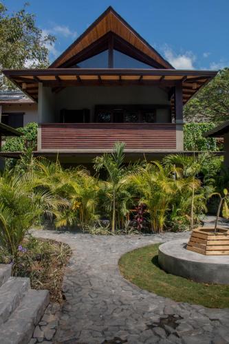 a house with a walkway in front of it at Lua Villas in Santa Teresa Beach