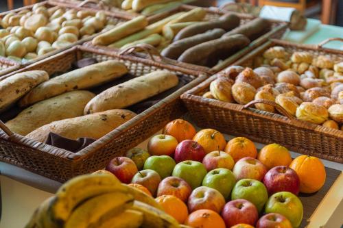 a display of fruits and vegetables in baskets on a table at Vila Baleira Porto Santo in Porto Santo