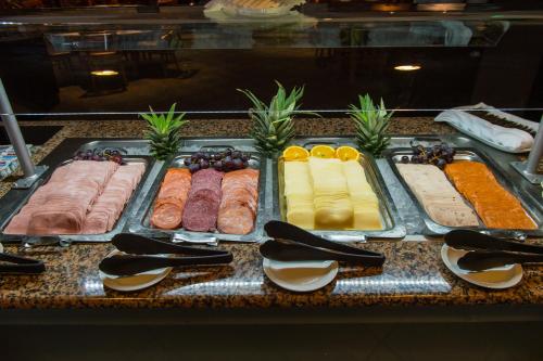 a buffet with different types of meats and cheese at Vila Baleira Porto Santo in Porto Santo